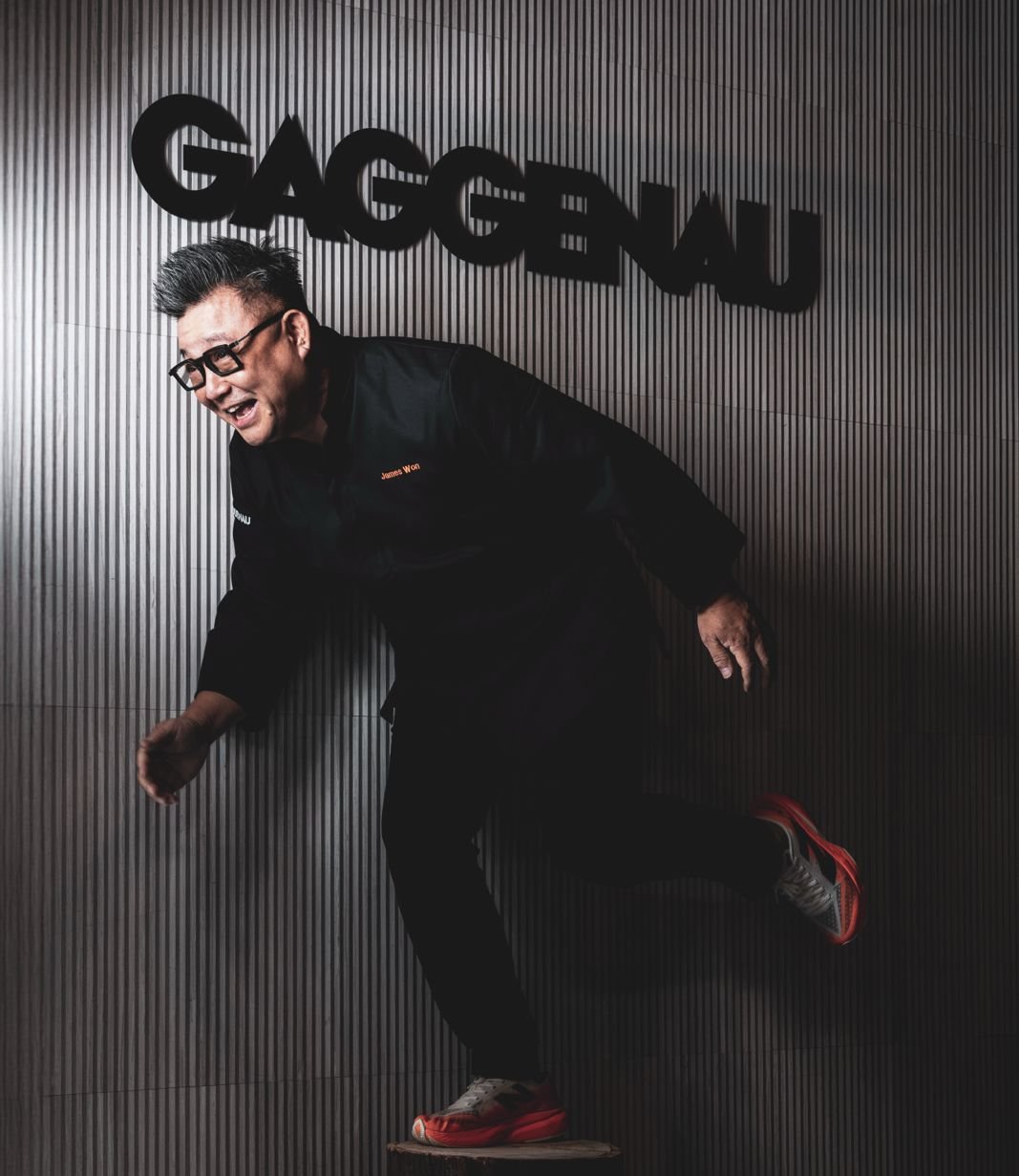 James Won mid-stride beneath the GAGGENAU sign — an action frame from the Inspiration Haus shoot.