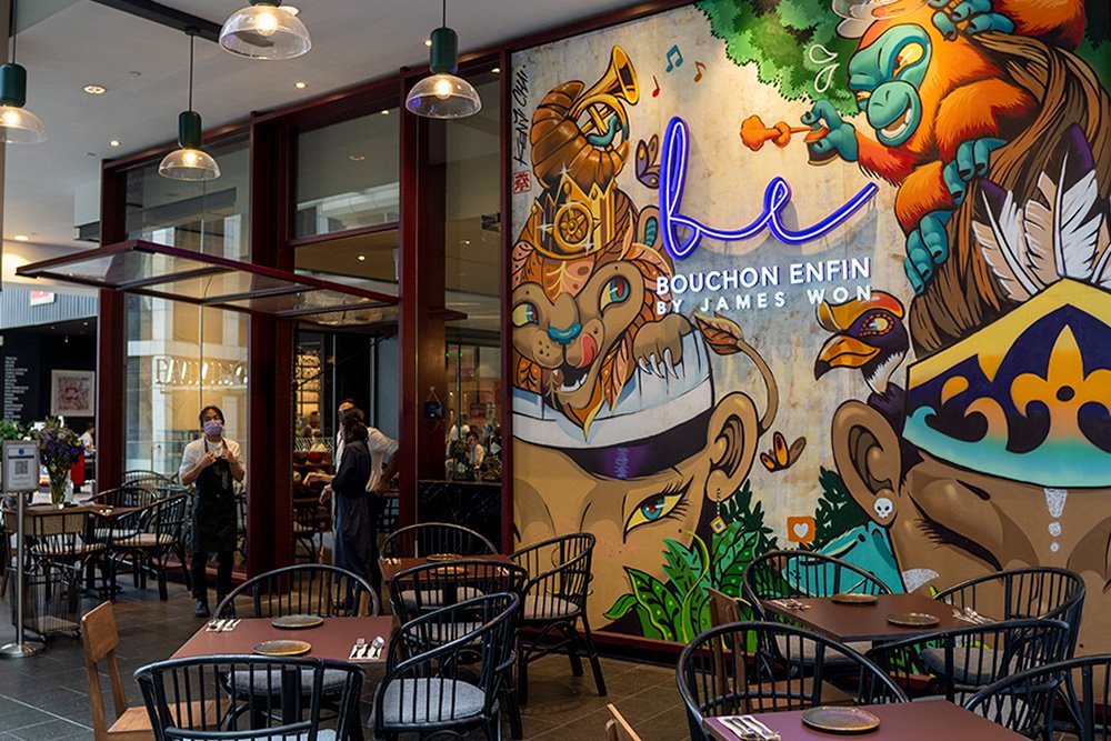 Bouchon Enfin at Pavilion Kuala Lumpur — front of house with the Kenji Chai mural and the neon Be signature.