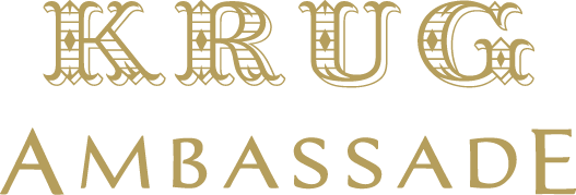 Krug Ambassade gold mark — reserved for the official Ambassade, embroidered on James Won's whites alone for twelve years.