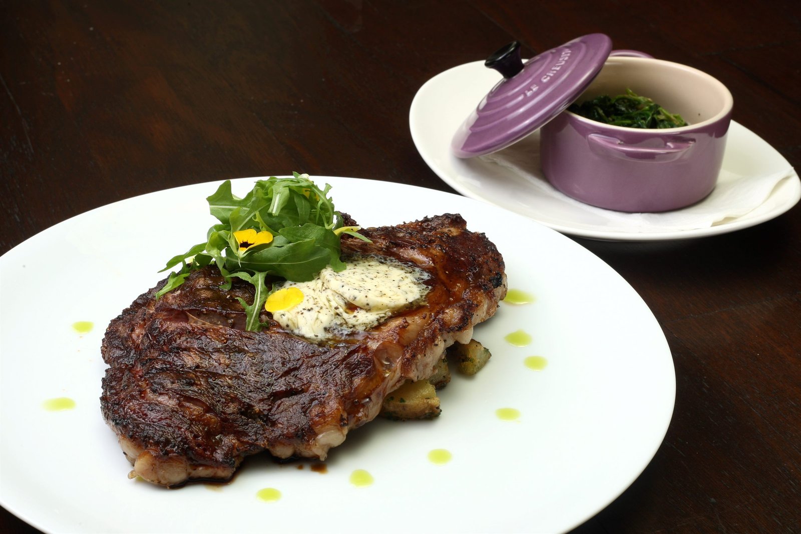 Ribeye on the charcoal — herb butter, root vegetables, bone jus, spinach creme.
